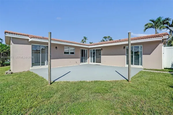 a view of a house with a yard and a porch
