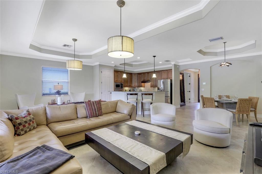 9530 Piacere Way Naples, FL 34113 - Photo 6 of 45 a living room with furniture kitchen view and a chandelier