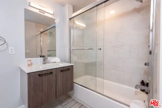 a bathroom with a granite countertop sink a toilet and bathtub