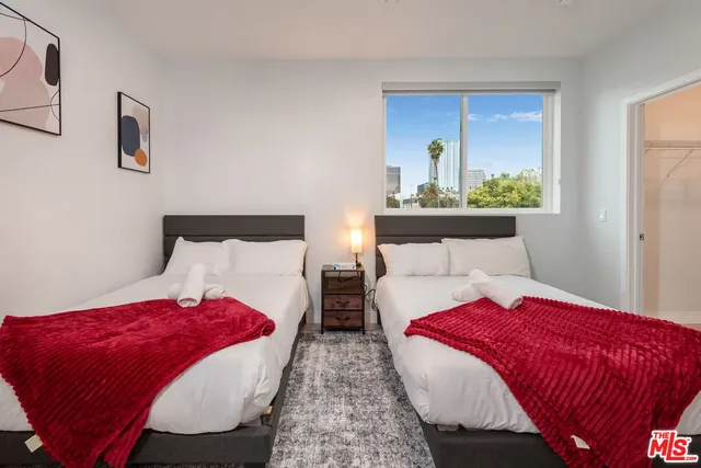 a bedroom with bed and window