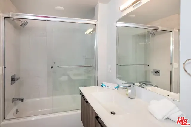 a bathroom with a sink and shower