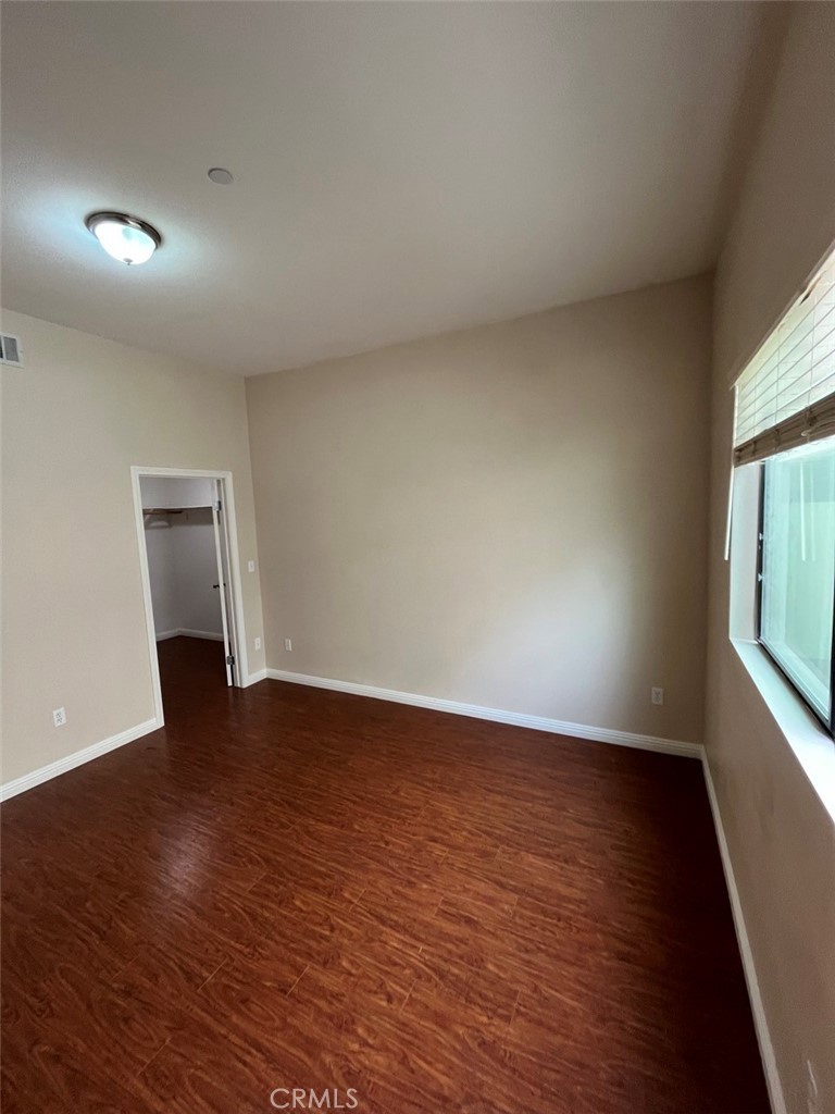 920 Central Riverside, CA 92507 - Photo 12 of 40 a view of an empty room with wooden floor and a window