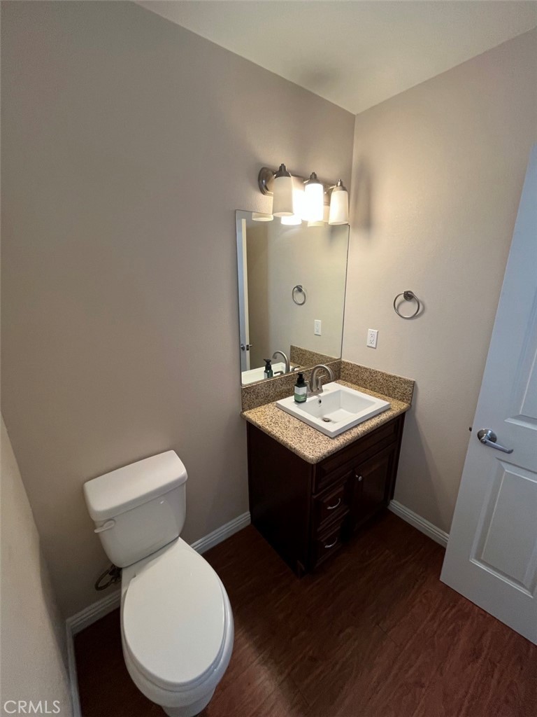 920 Central Riverside, CA 92507 - Photo 18 of 40 a bathroom with a toilet a sink and mirror