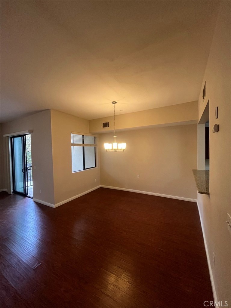 920 Central Riverside, CA 92507 - Photo 23 of 40 a view of an empty room with wooden floor and a window