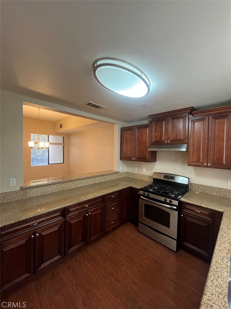 920 Central Riverside, CA 92507 - Photo 24 of 40 a kitchen with stainless steel appliances granite countertop a stove a sink and a granite counter tops