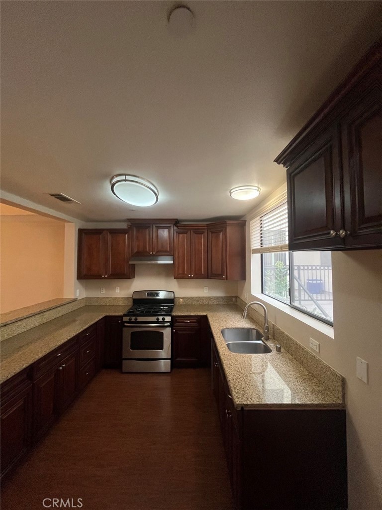 920 Central Riverside, CA 92507 - Photo 25 of 40 a kitchen with stainless steel appliances granite countertop a sink stove and cabinets