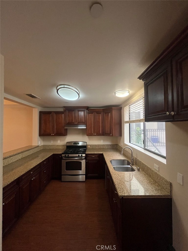 920 Central Riverside, CA 92507 - Photo 26 of 40 a kitchen with stainless steel appliances granite countertop a sink stove and refrigerator