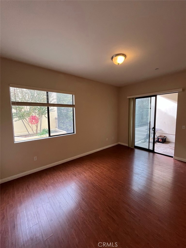 920 Central Riverside, CA 92507 - Photo 3 of 40 a view of an empty room with wooden floor and a window