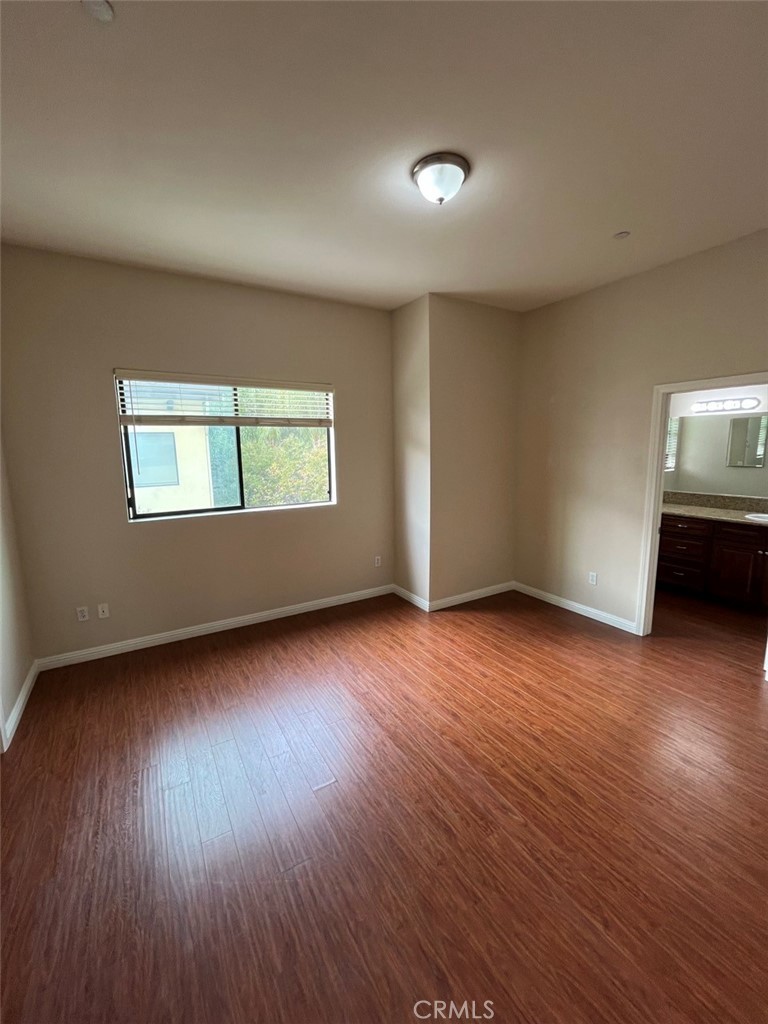920 Central Riverside, CA 92507 - Photo 31 of 40 an empty room with wooden floor and windows