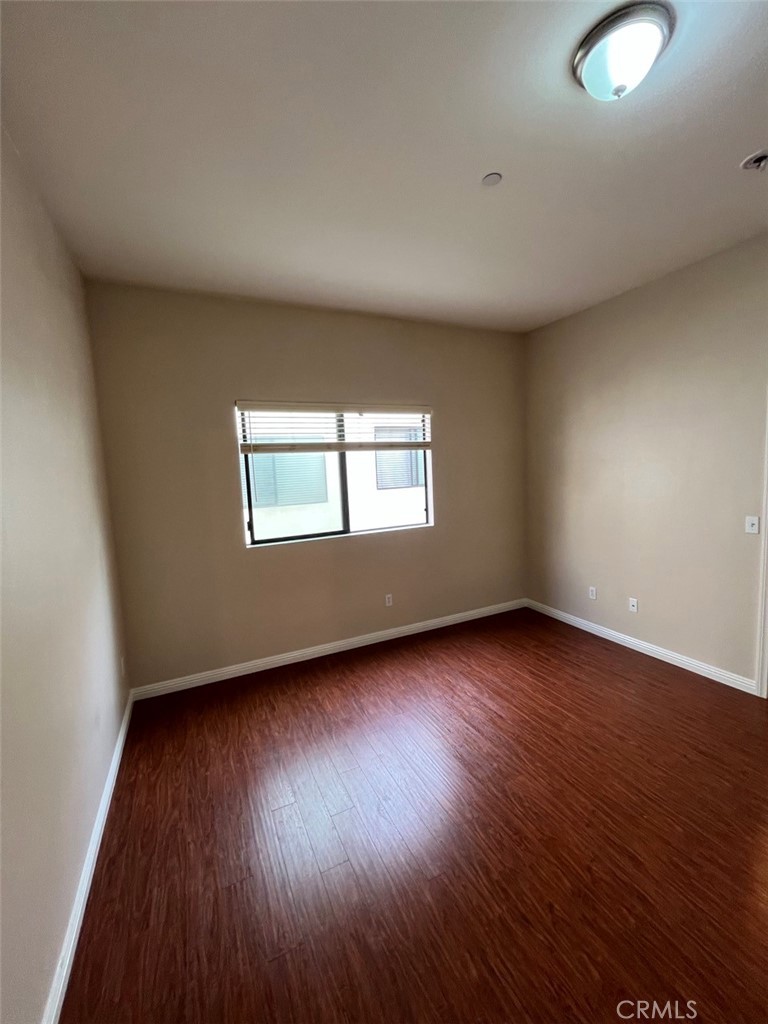 920 Central Riverside, CA 92507 - Photo 8 of 40 a view of an empty room with wooden floor and a window