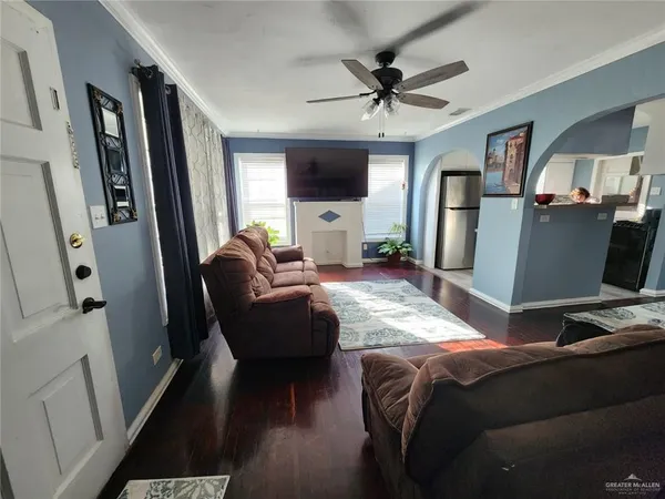 a living room with furniture window and a flat screen tv