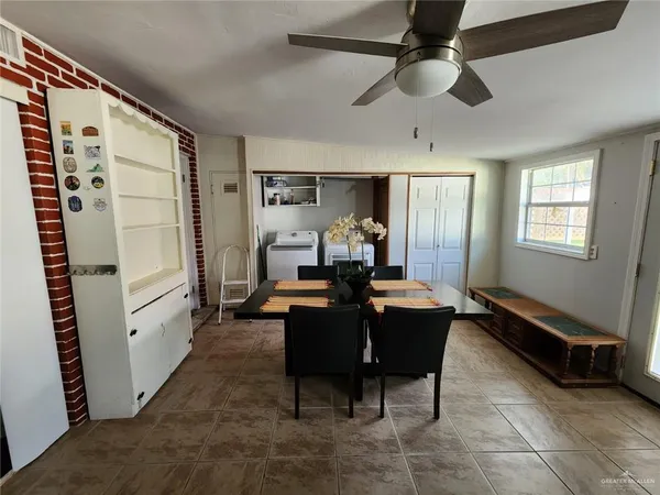 a dining room with furniture and window