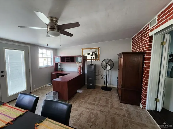 a living room with furniture a window and a wooden floor