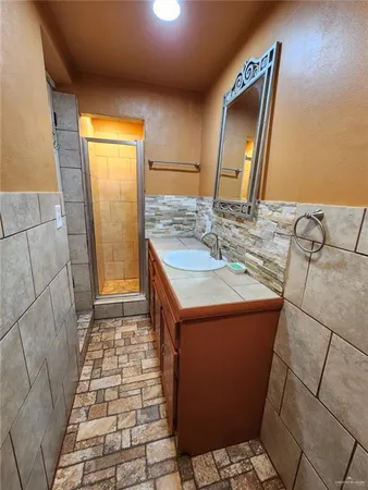 a bathroom with a sink a toilet and mirror