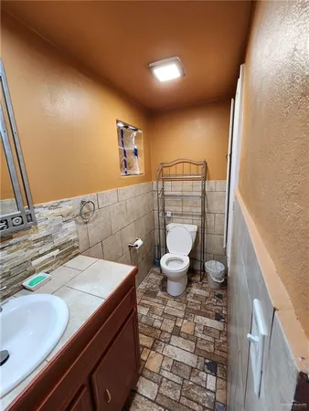 a bathroom with a sink mirror vanity and toilet