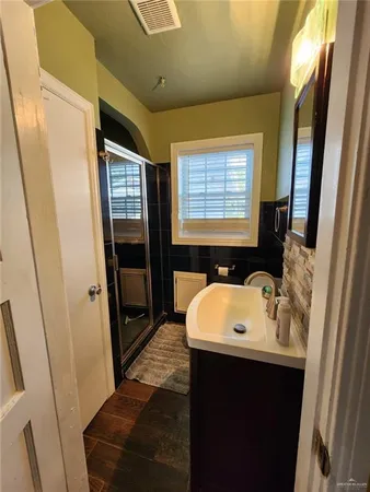 a bathroom with a sink a mirror and a bathtub