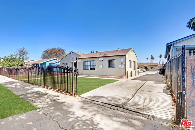 a view of a house next to a yard