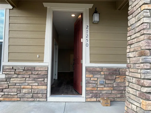 a view of front door of house with stairs