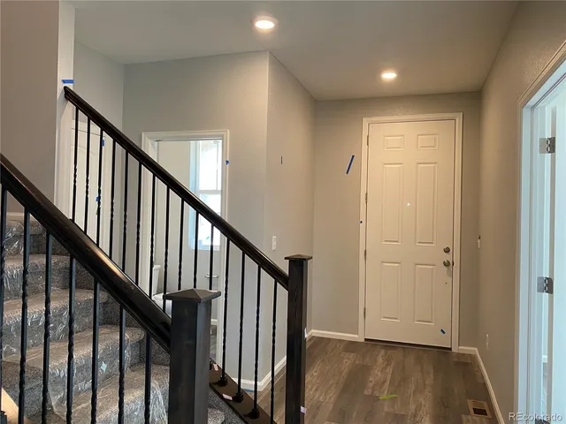 a view of an entryway with wooden floor