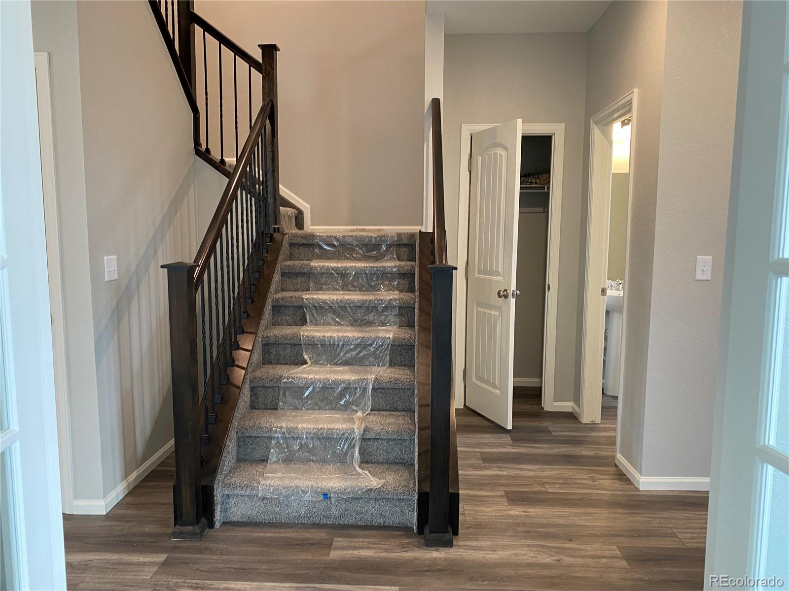 21250 East Radcliff Place Aurora, CO 80015 - Photo 5 of 11 a view of a hallway with wooden floor and entryway