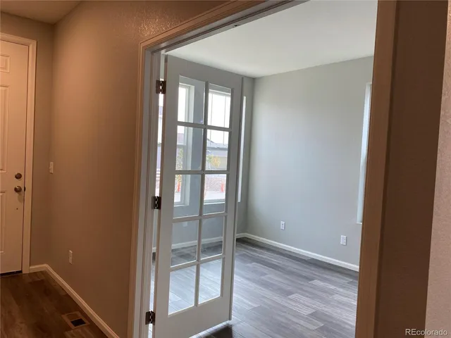a view of hallway with wooden floor