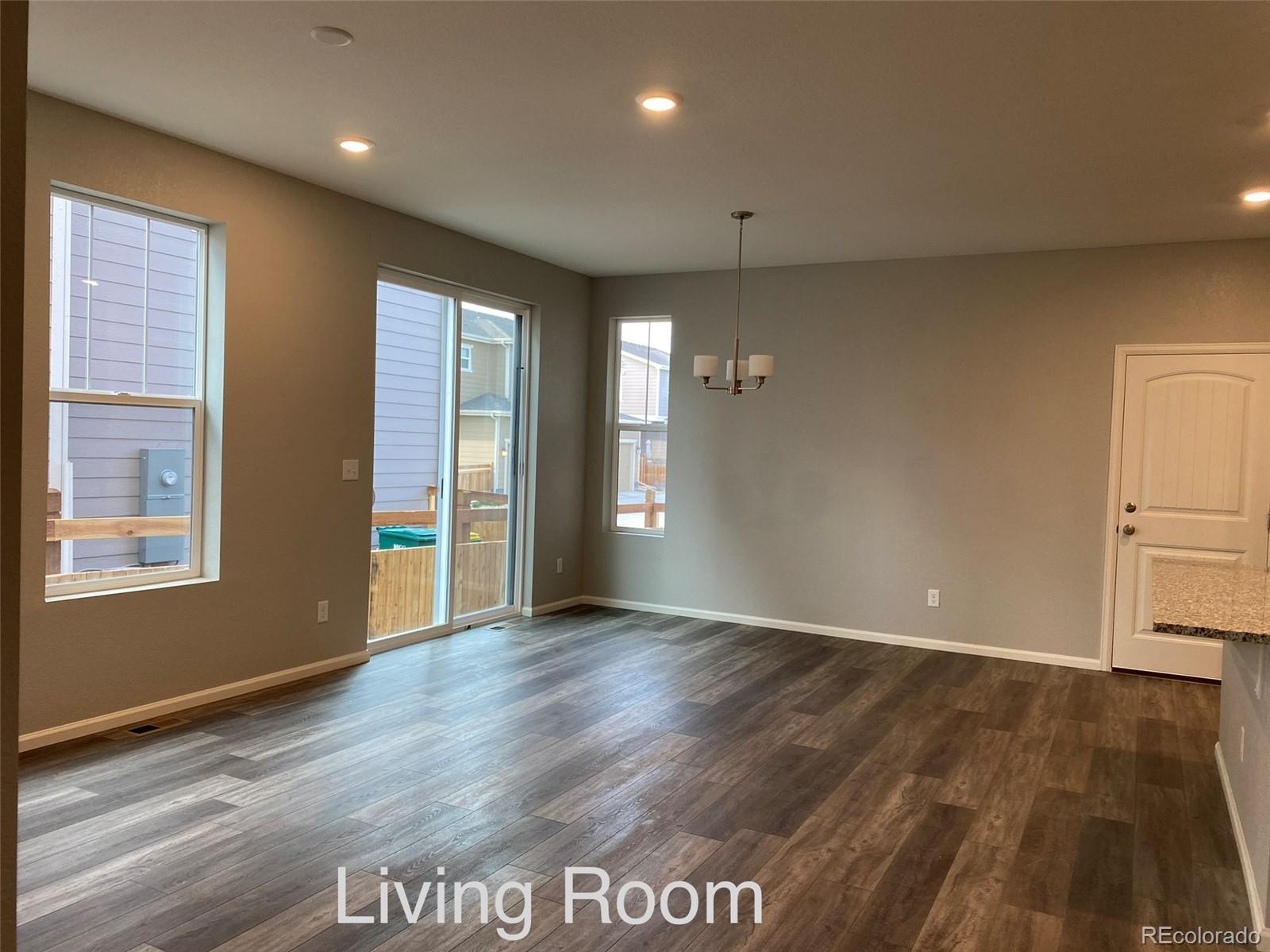 21250 East Radcliff Place Aurora, CO 80015 - Photo 7 of 11 a view of an empty room with wooden floor and a window