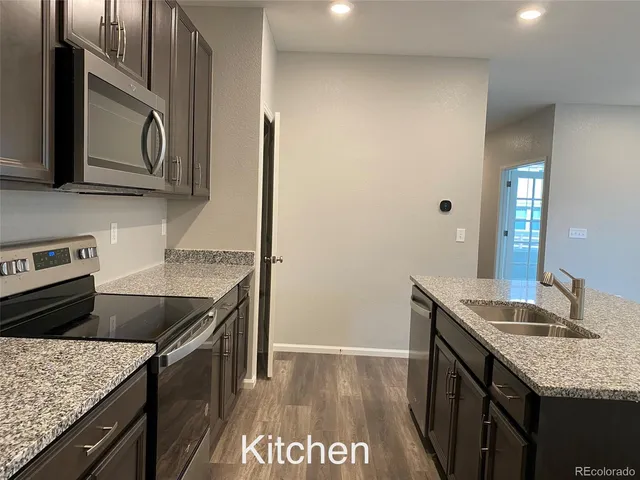 a view of a kitchen from the hallway
