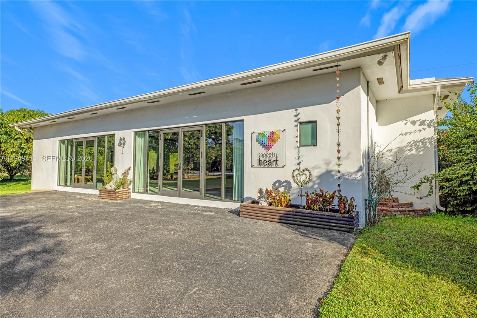27950 Southwest 182nd Avenue Homestead, FL 33031 - Photo 11 of 49 a couple of potted plants sitting in front of a house