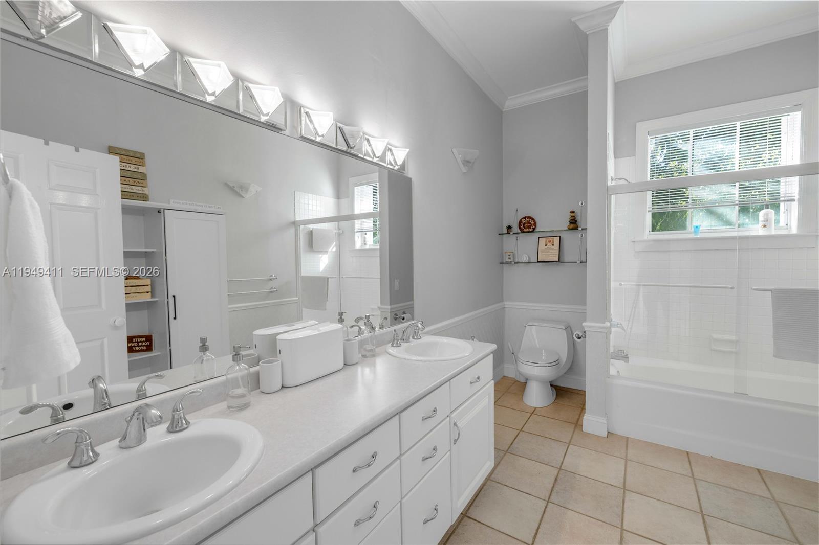 27950 Southwest 182nd Avenue Homestead, FL 33031 - Photo 14 of 49 a spacious bathroom with a double vanity sink a mirror and a bathtub