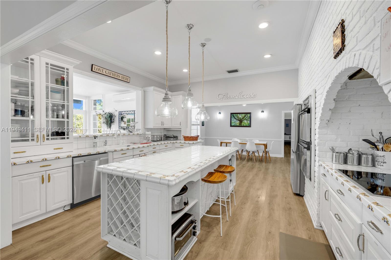 27950 Southwest 182nd Avenue Homestead, FL 33031 - Photo 23 of 49 an open kitchen with a sink and a stove top oven
