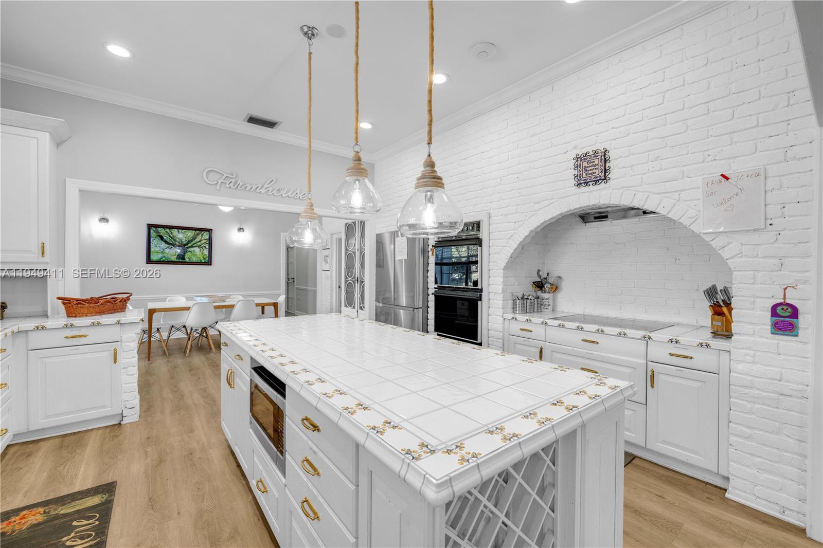 27950 Southwest 182nd Avenue Homestead, FL 33031 - Photo 24 of 49 a large kitchen with kitchen island a stove a sink a center island and couches