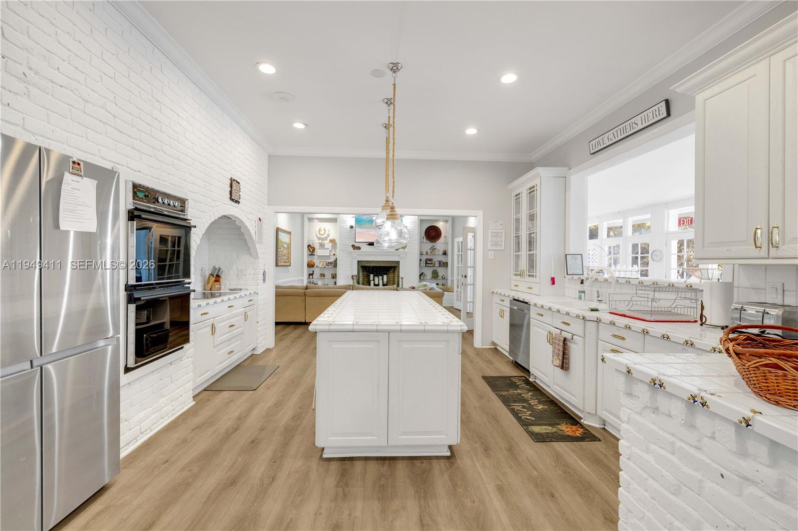 27950 Southwest 182nd Avenue Homestead, FL 33031 - Photo 27 of 49 a kitchen with stainless steel appliances a stove a sink a refrigerator cabinets and wooden floor