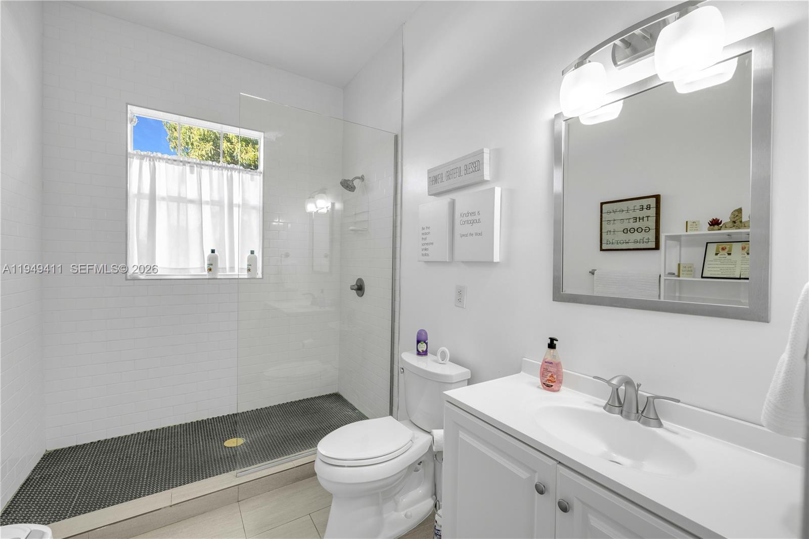 27950 Southwest 182nd Avenue Homestead, FL 33031 - Photo 30 of 49 a bathroom with a sink toilet and a mirror
