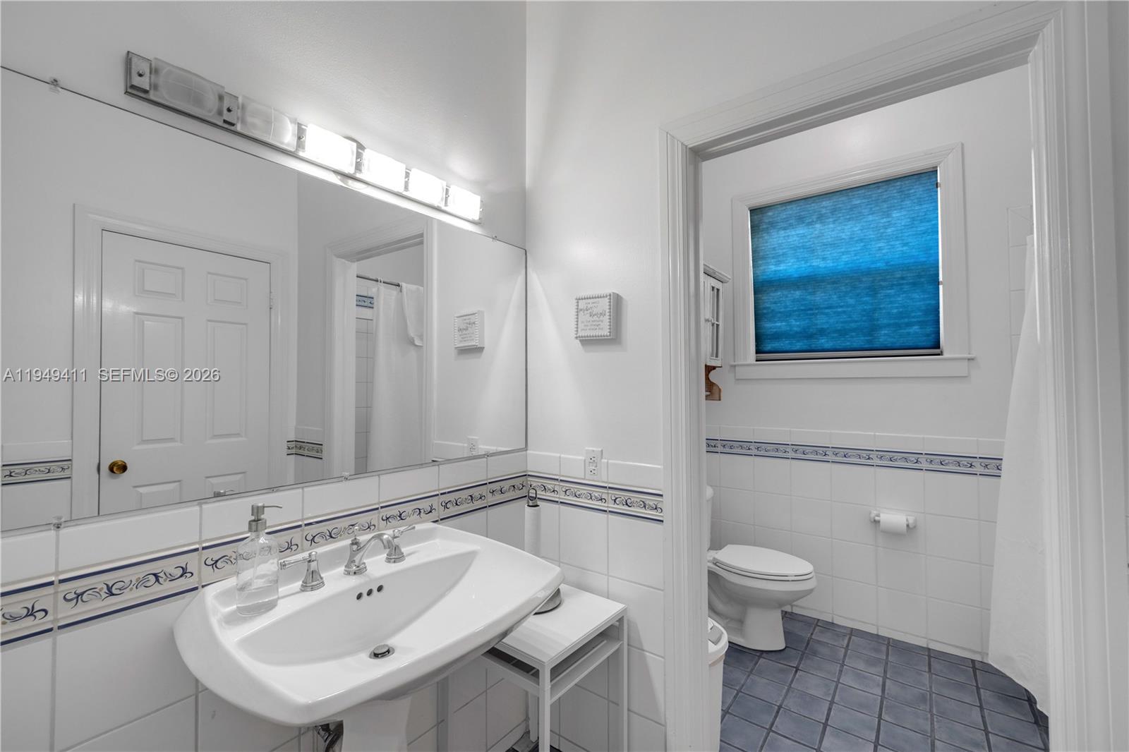 27950 Southwest 182nd Avenue Homestead, FL 33031 - Photo 31 of 49 a bathroom with a toilet a sink and mirror