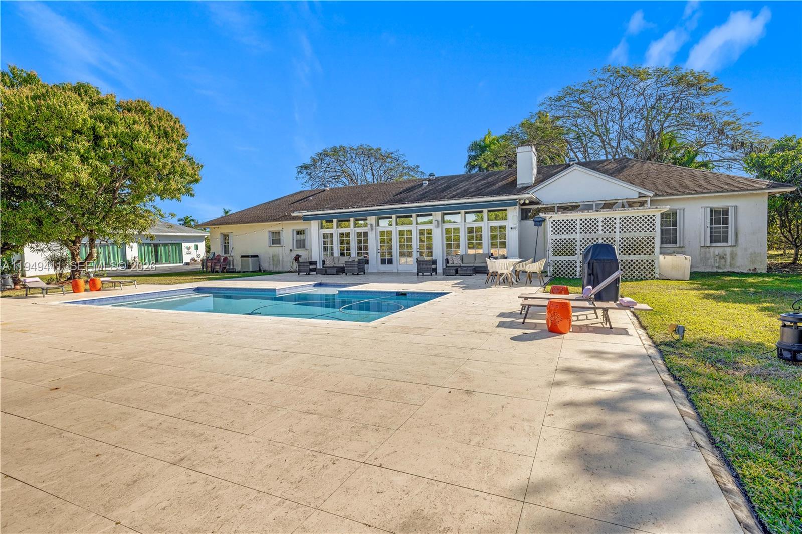 27950 Southwest 182nd Avenue Homestead, FL 33031 - Photo 38 of 49 a view of a house with swimming pool and sitting area