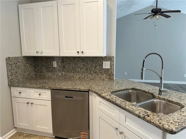 a view of an empty room with wooden floor fireplace and a window
