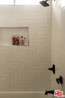 a bedroom with a bed and glass door