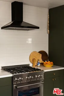 a kitchen with stainless steel appliances a stove a refrigerator and a sink