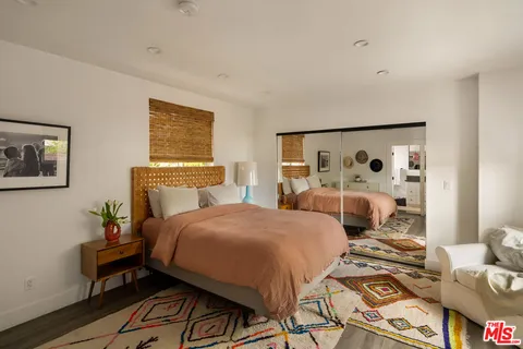 a bedroom with a bed and cabinets