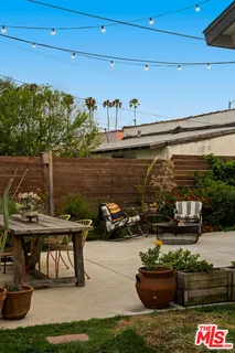 a view of a patio with table and chairs potted plants with wooden floor and potted plants