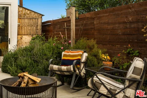 a view of a backyard with plants and a patio