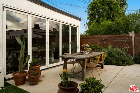 a room with furniture pool table and potted plants