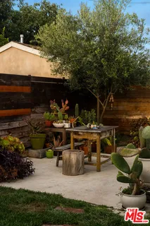 a view of house with backyard space and balcony