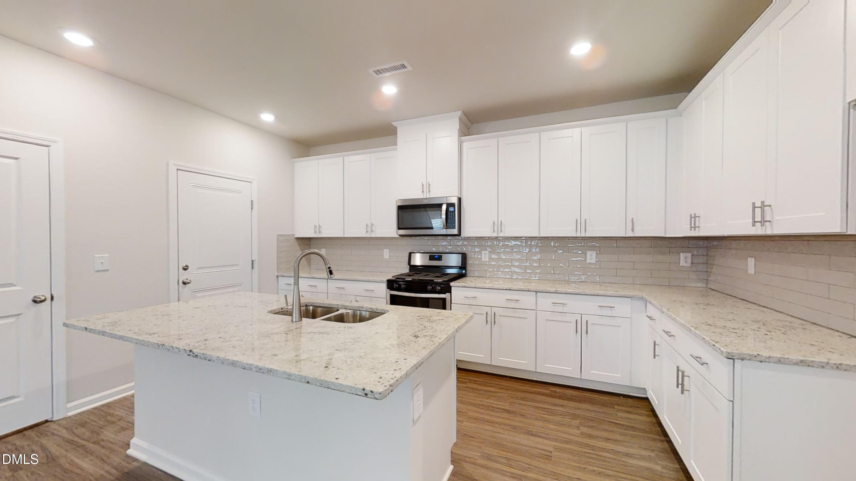 46 Coffee Tree Circle Clayton, NC 27527 - Photo 14 of 46 a kitchen with granite countertop white cabinets and stainless steel appliances