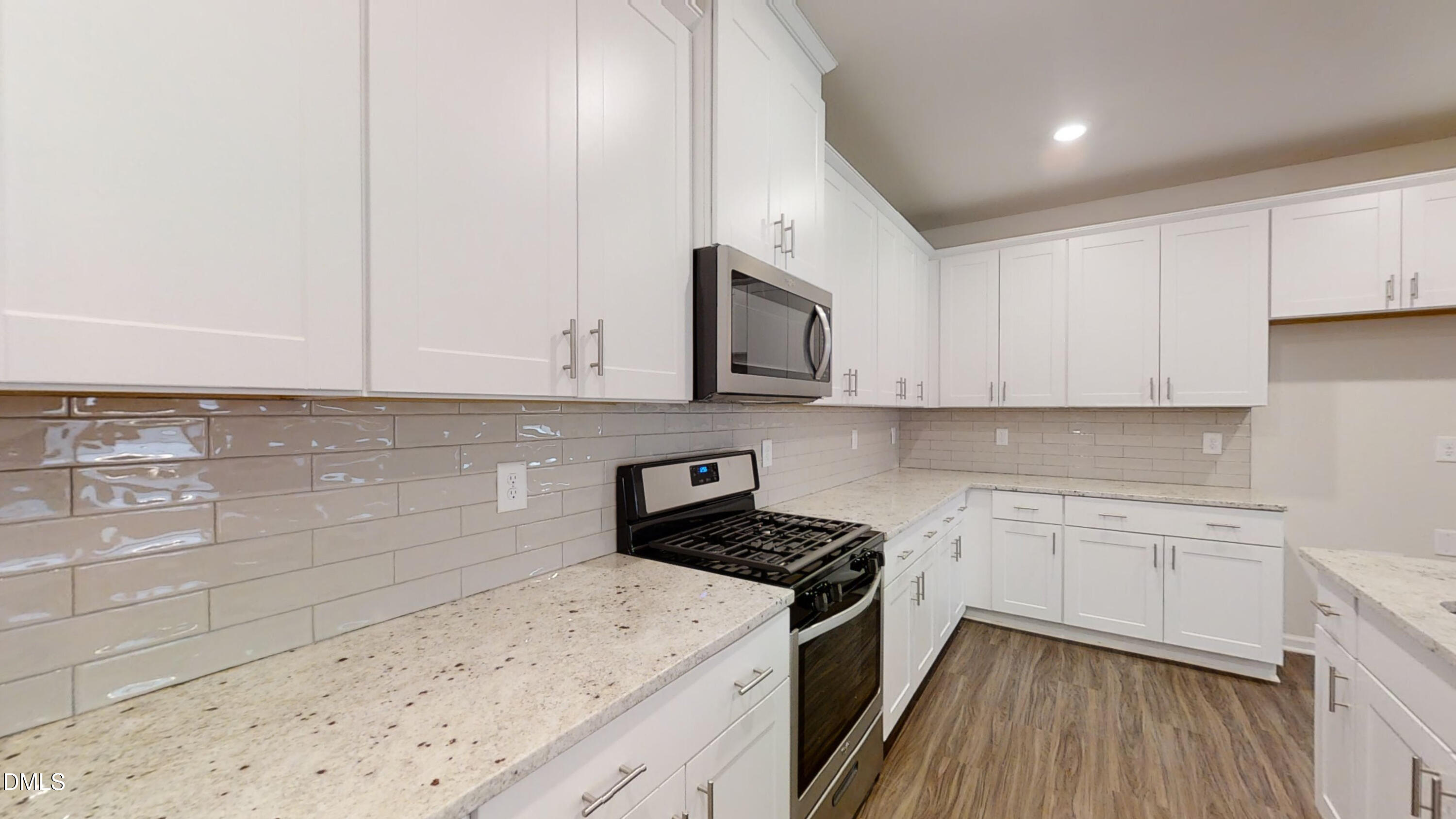 46 Coffee Tree Circle Clayton, NC 27527 - Photo 15 of 46 a kitchen with granite countertop white cabinets and white appliances