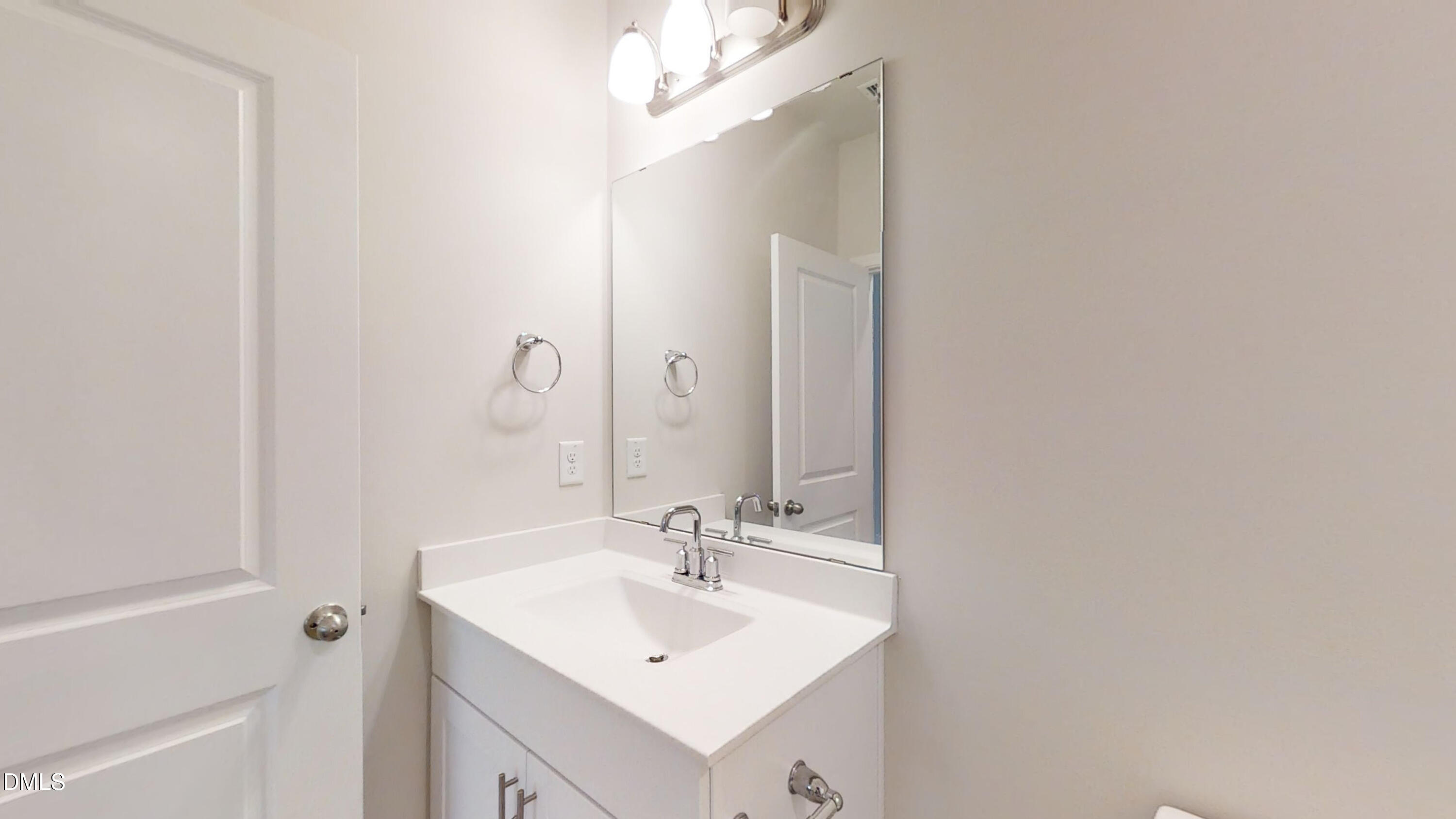 46 Coffee Tree Circle Clayton, NC 27527 - Photo 19 of 46 a bathroom with a sink and a mirror