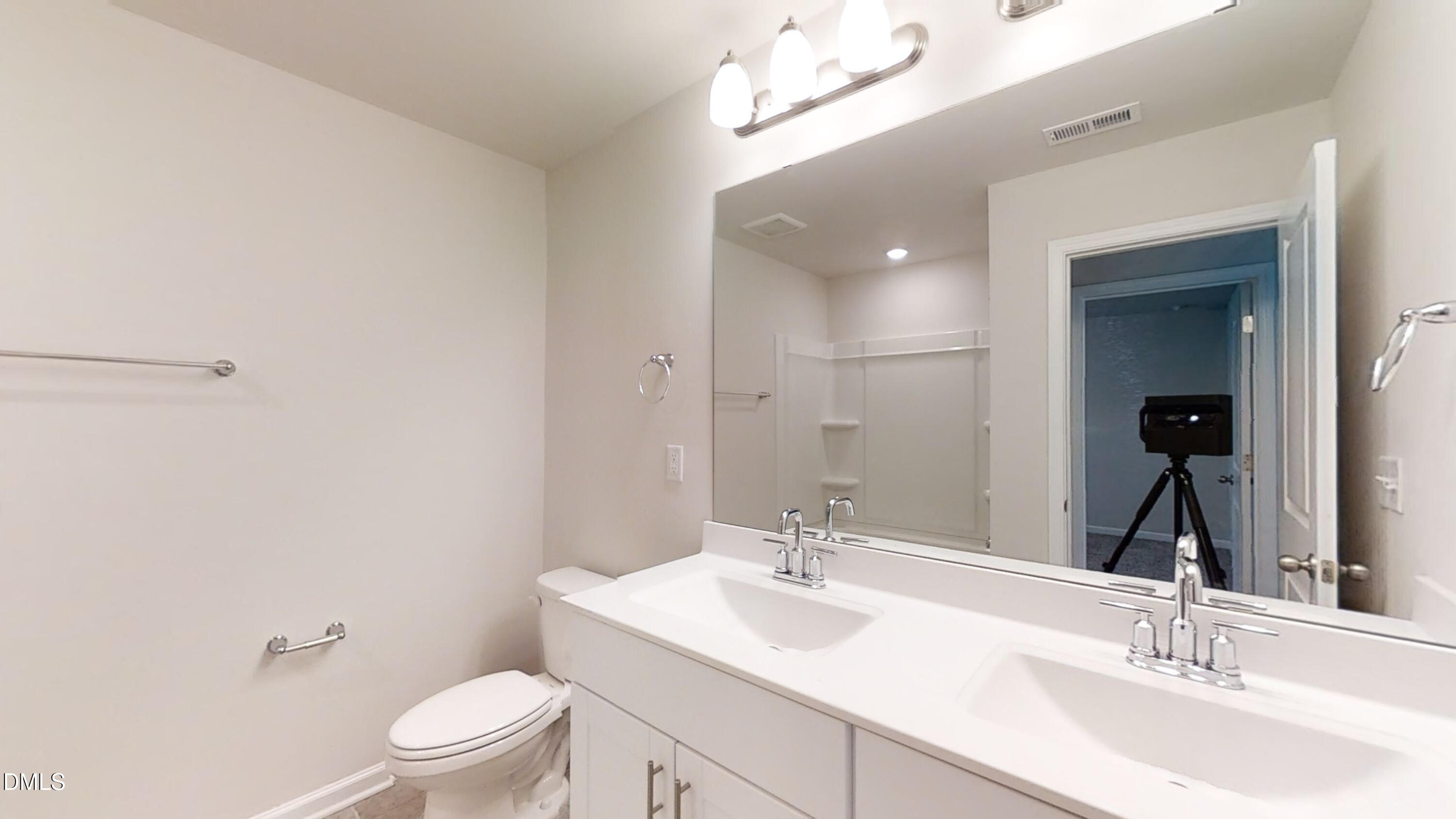 46 Coffee Tree Circle Clayton, NC 27527 - Photo 22 of 46 a bathroom with a toilet a sink a mirror and vanity
