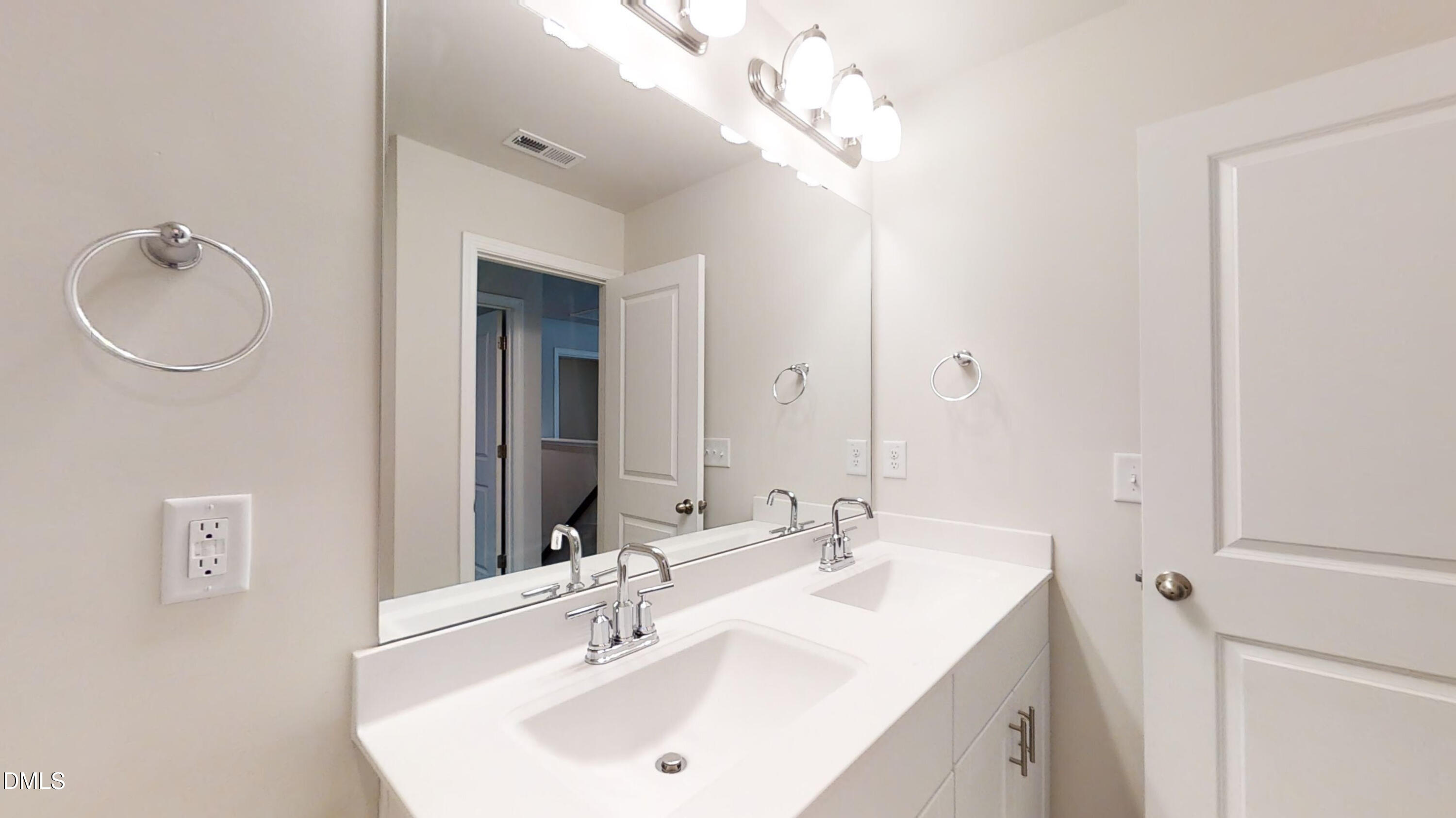 46 Coffee Tree Circle Clayton, NC 27527 - Photo 26 of 46 a bathroom with a sink a mirror and a light fixture