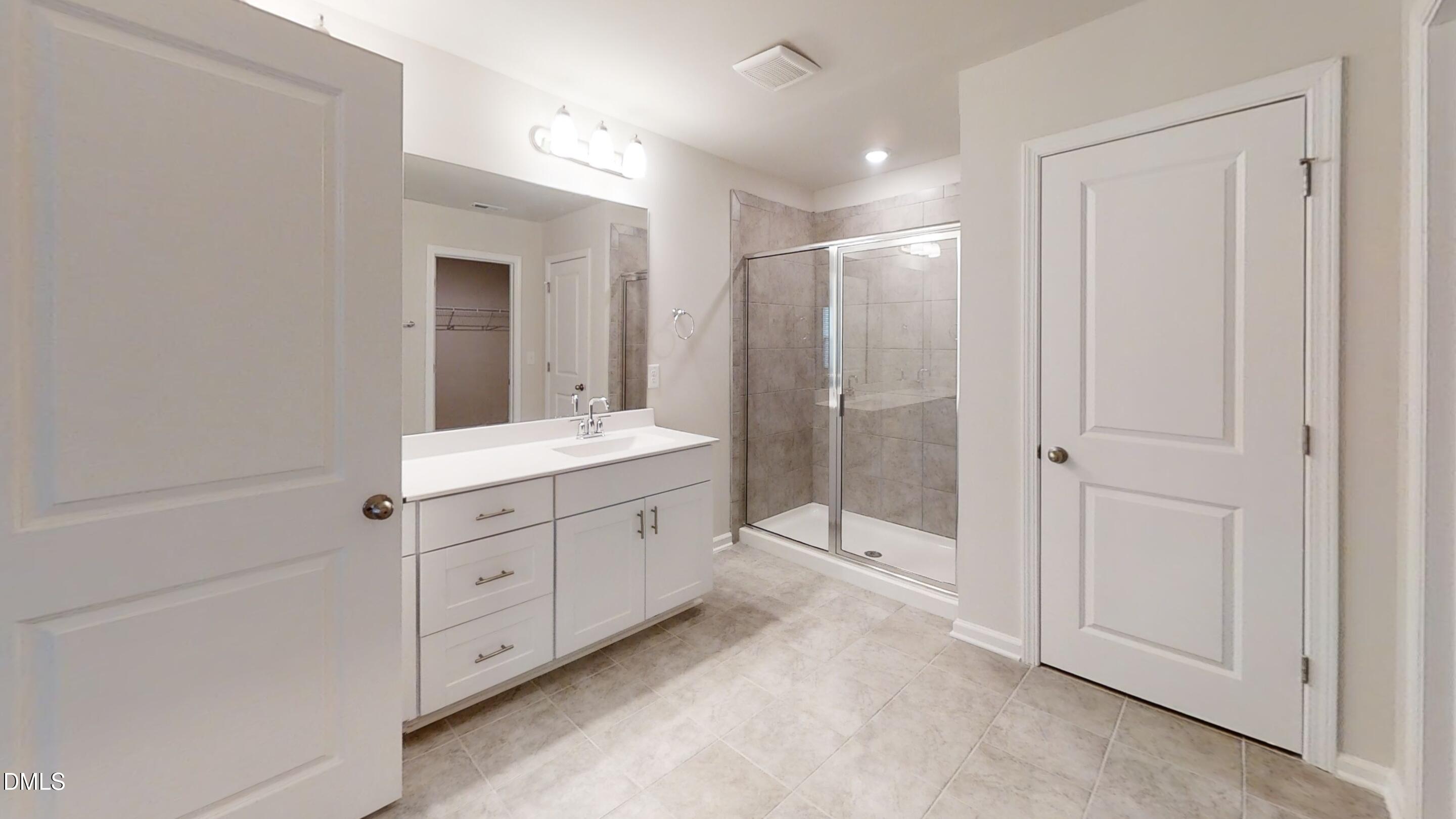 46 Coffee Tree Circle Clayton, NC 27527 - Photo 35 of 46 a bathroom with a double vanity sink mirror and shower