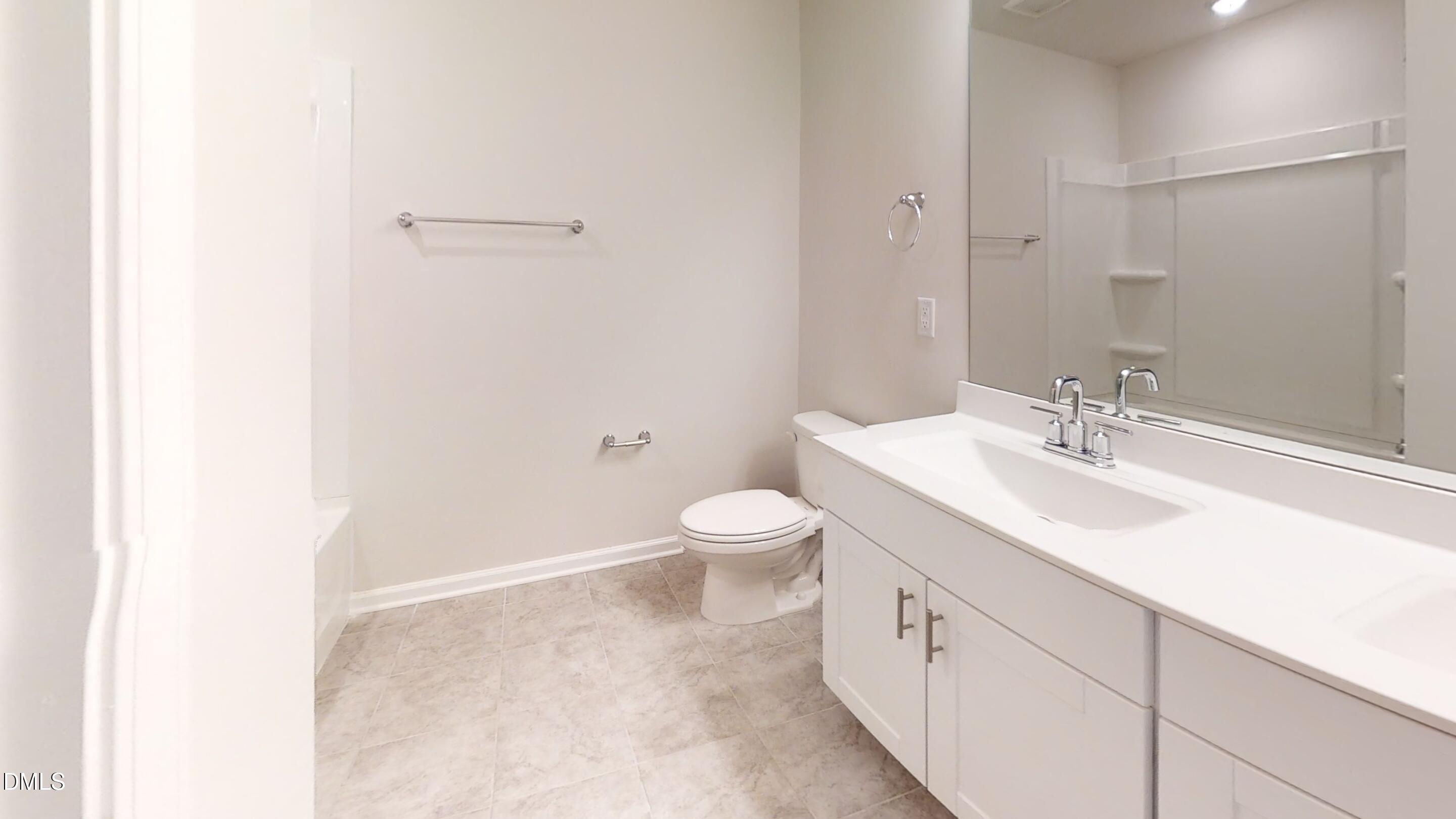 46 Coffee Tree Circle Clayton, NC 27527 - Photo 36 of 46 a bathroom with a double vanity sink toilet and a mirror